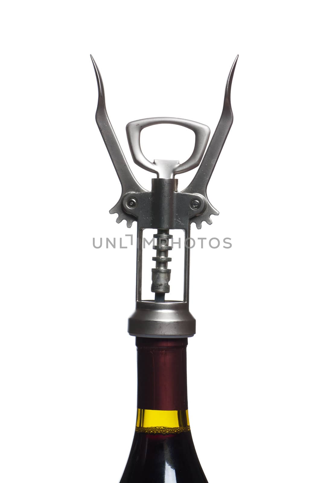 Corkscrew over the wine bottle isolated on white