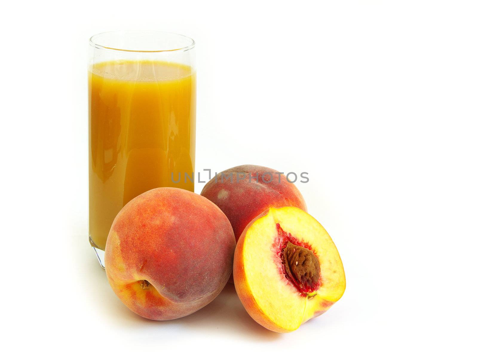 Glass with freshly made peach juice on a white background