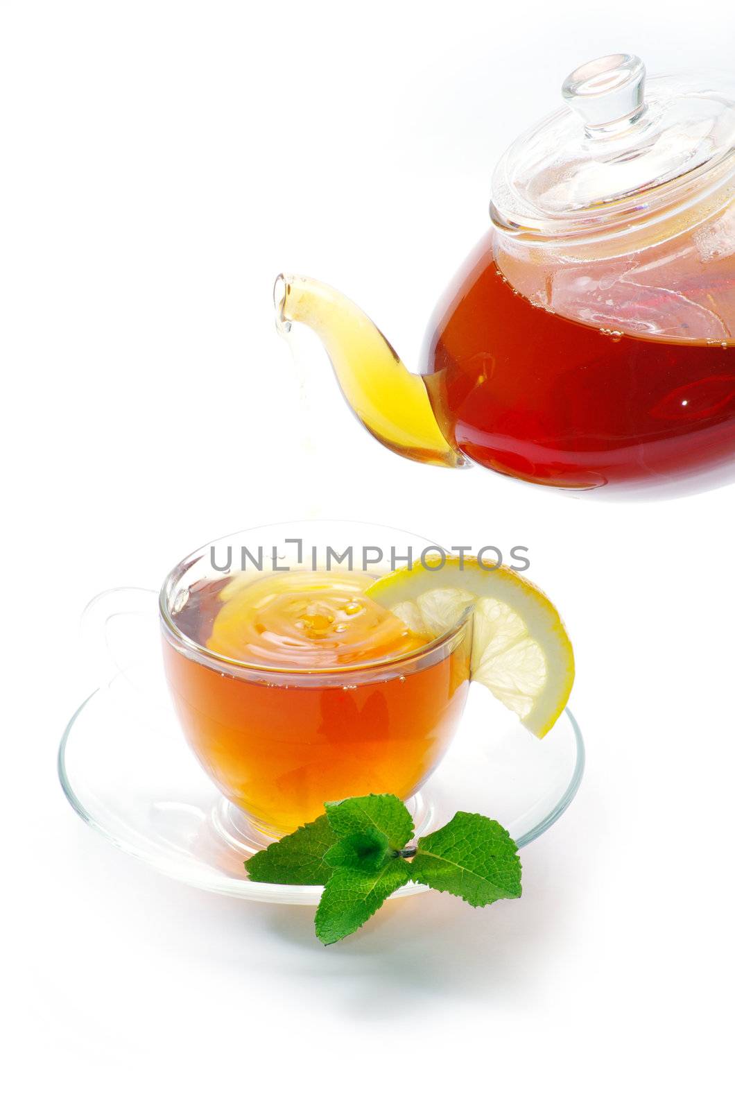 Tea being poured into glass tea cup