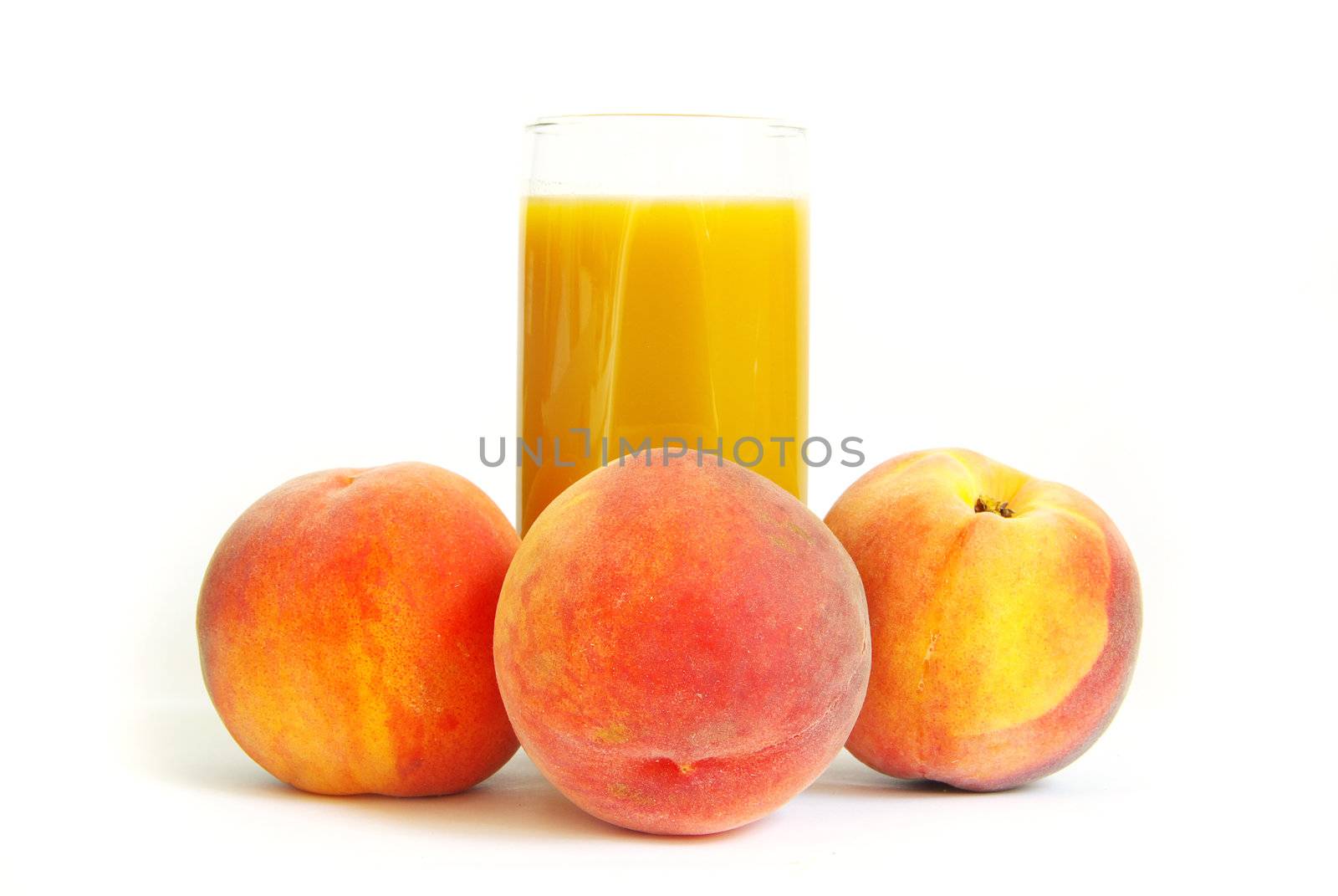 Glass with freshly made peach juice on a white background