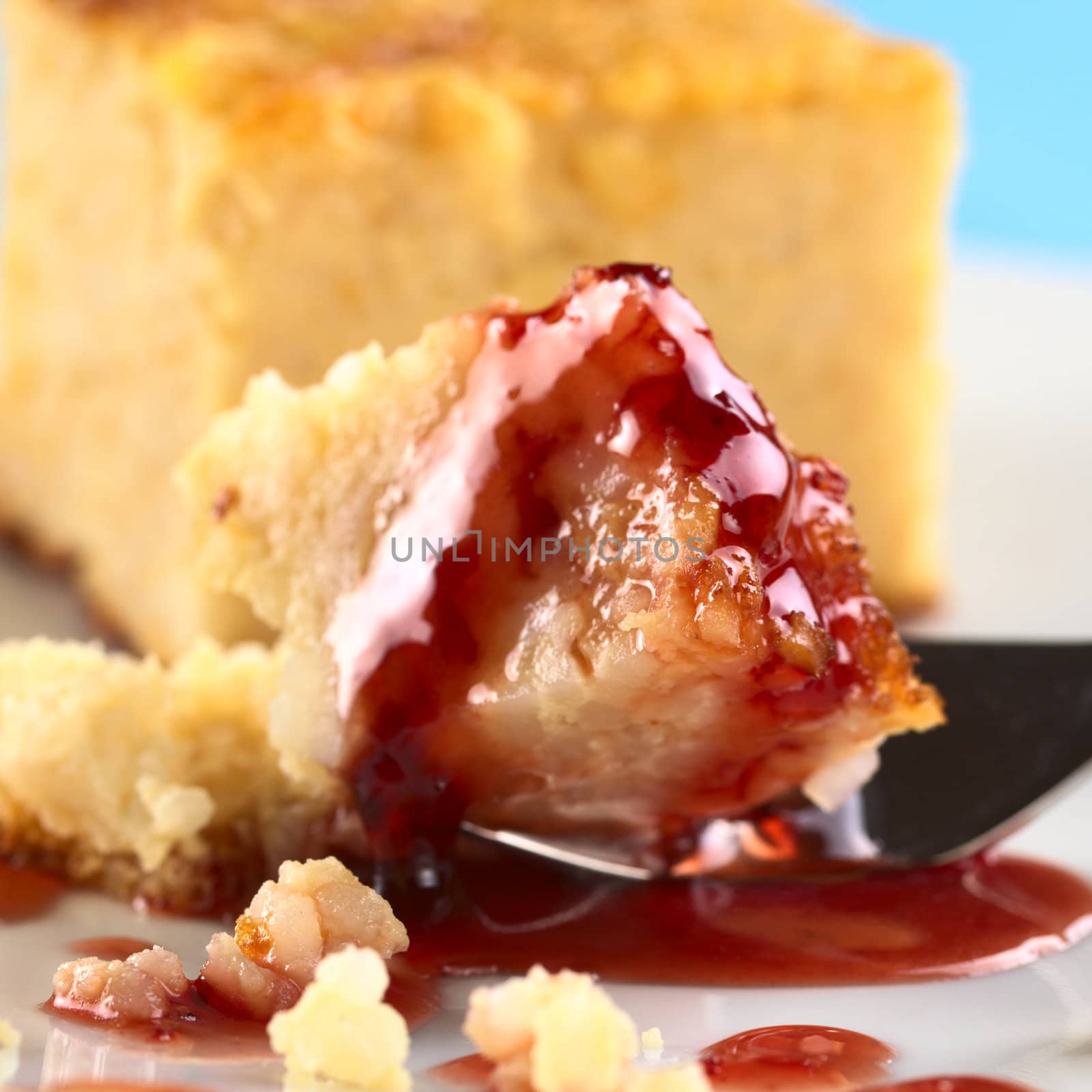 Strawberry syrup on baked rice pudding (Selective Focus, Focus on the front of the cake and the syrup)