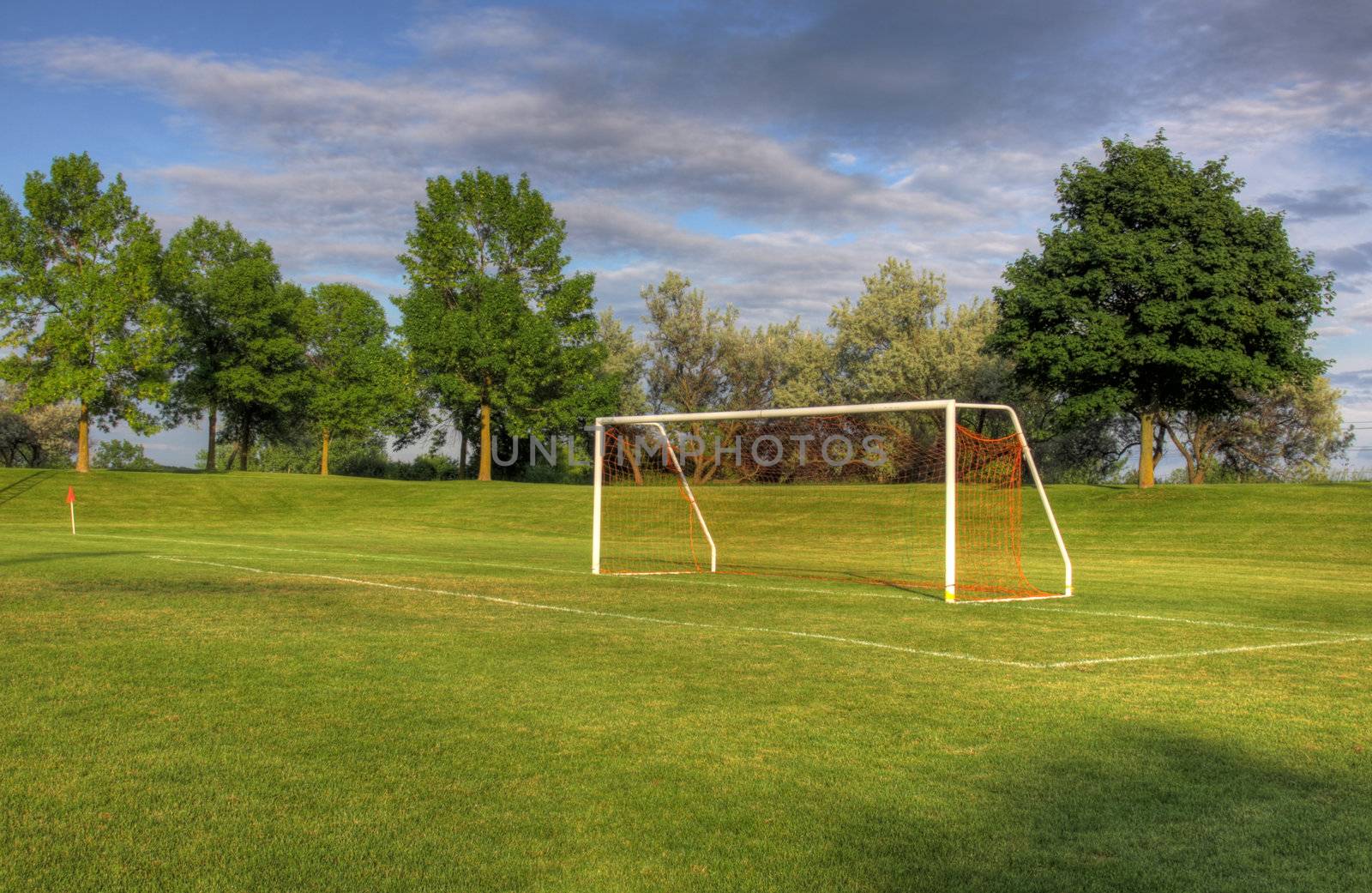 An empty soccer goal with trees in the background. (HDR photo)
