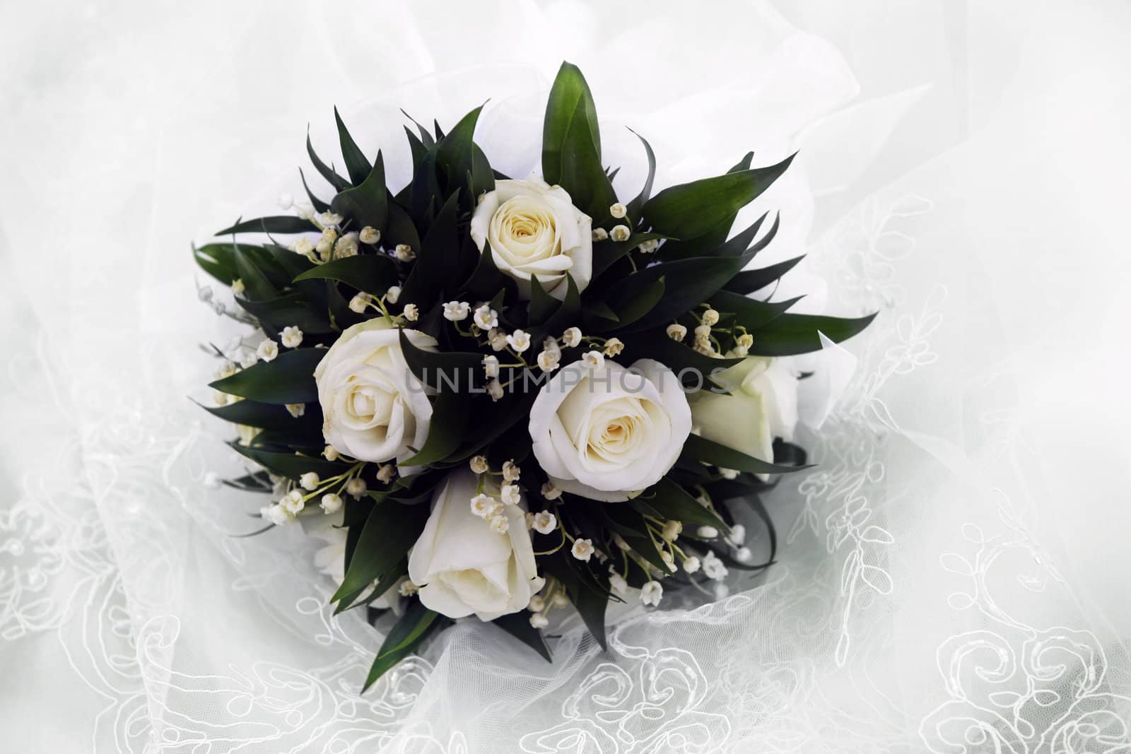 Wedding bouquet on a background of a veil