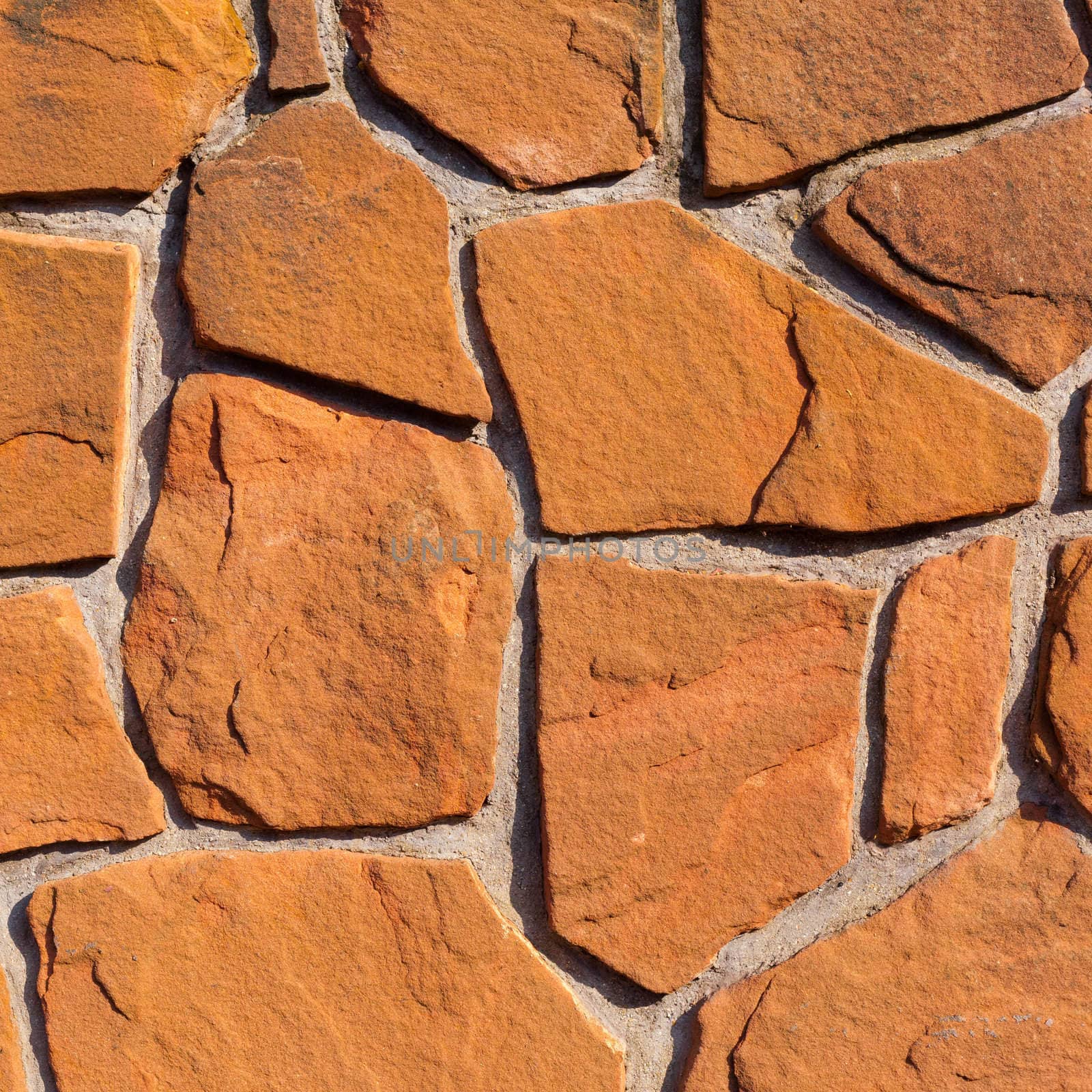 Rough sandstone and mortar wall background texture pattern.