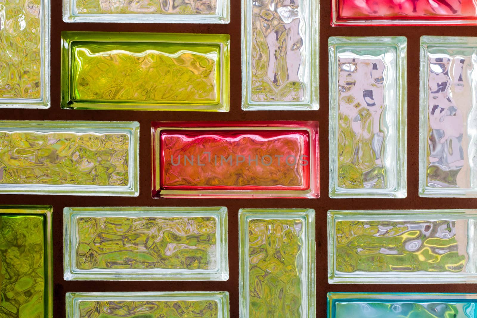 Light distorting colorful glass block window mosaic background pattern texture.