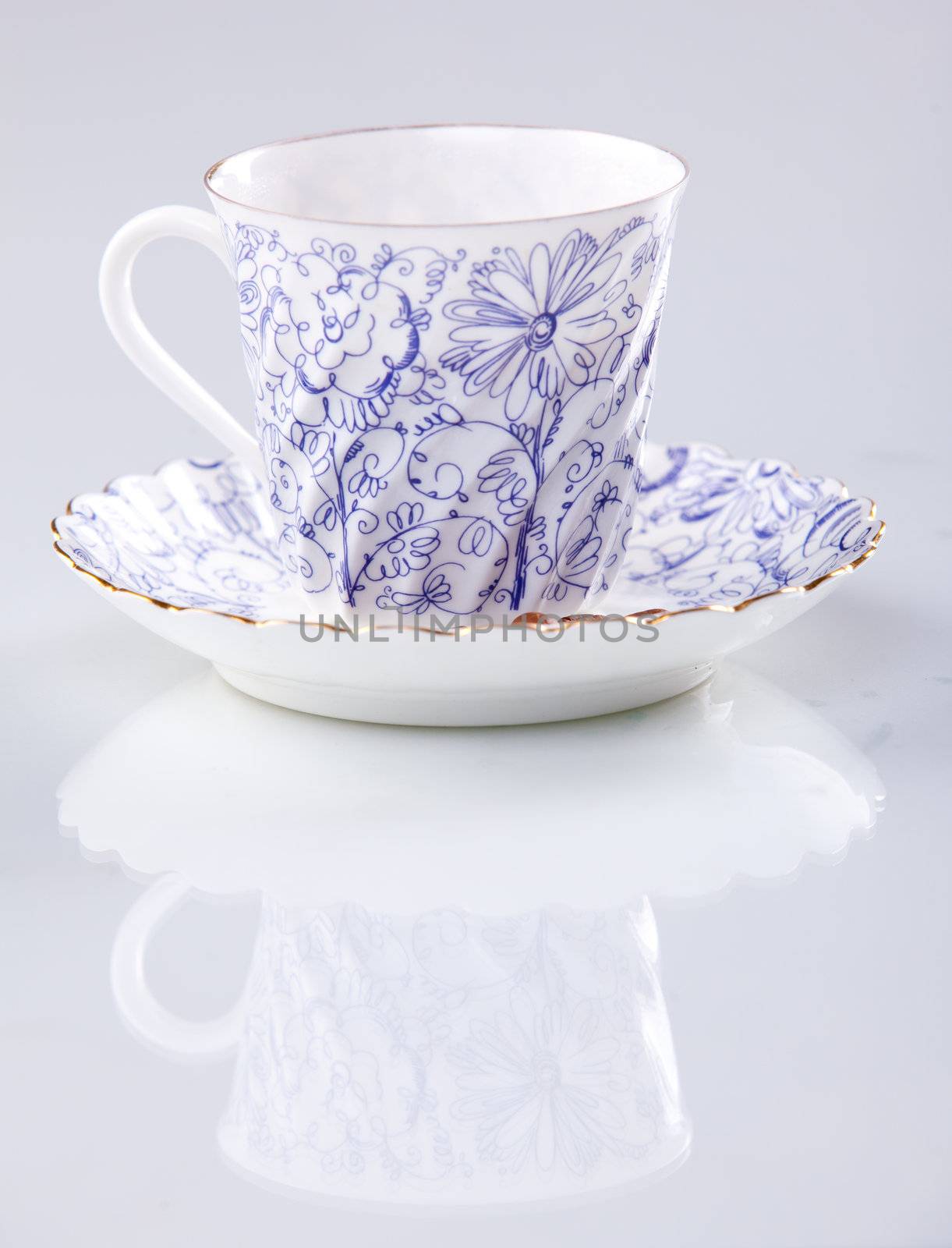 close up of a coffee cup with a floral pattern with reflection