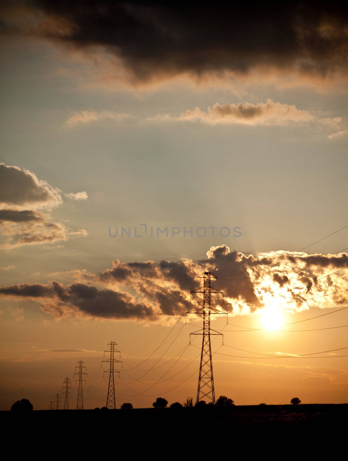 landscape with high tension wires over sky