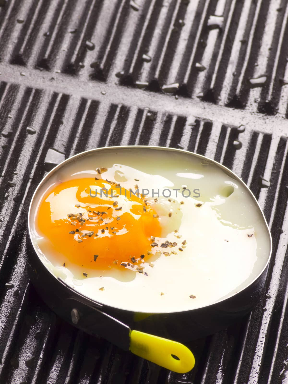 close up of fried egg on a grill
