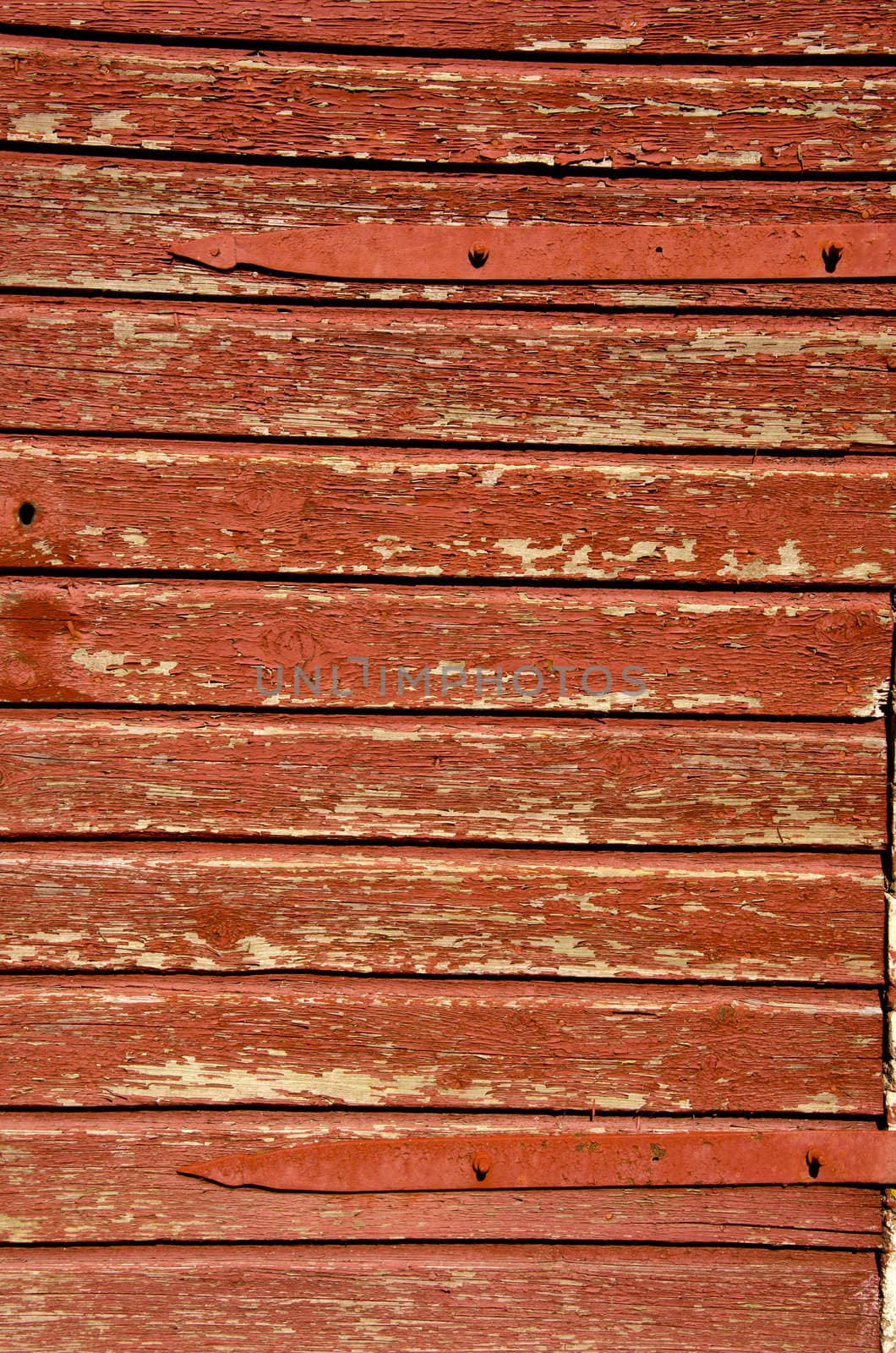 Fragment of old brown painted building wall made of wooden planks.