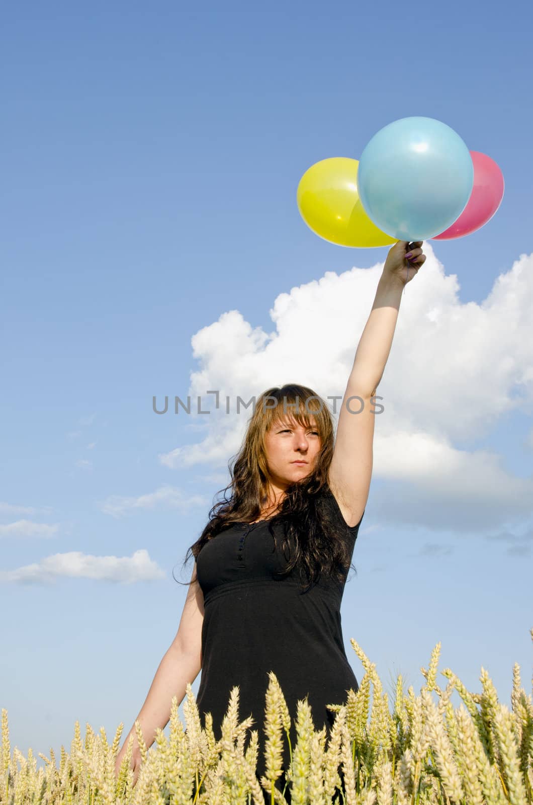 Young woman holding balloons by sauletas