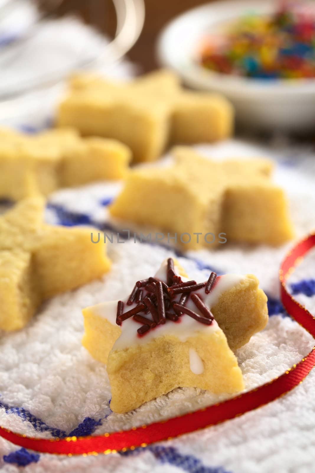 Star shaped cookie with sugar icing and chocolate sprinkles (Selective Focus, Focus on the middle of the first cookie)