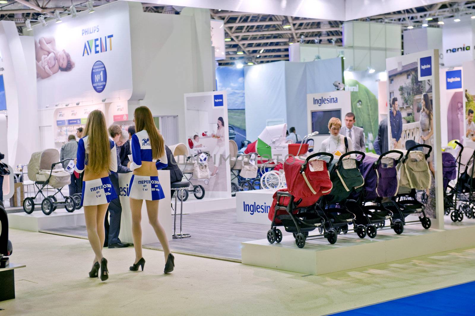 Two beautiful girls at an exhibition of the children's goods in Moscow, Russia