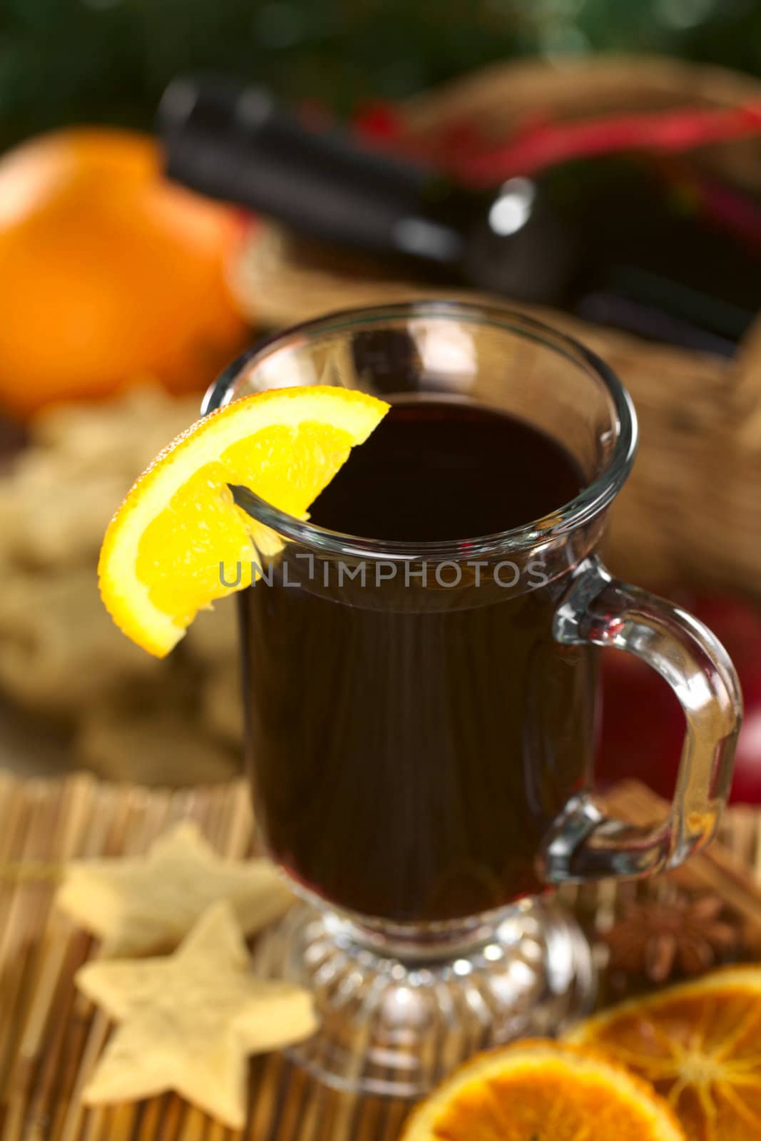 Hot spiced mulled wine garnished with orange slice (Selective Focus, Focus on the front rim of the glass)