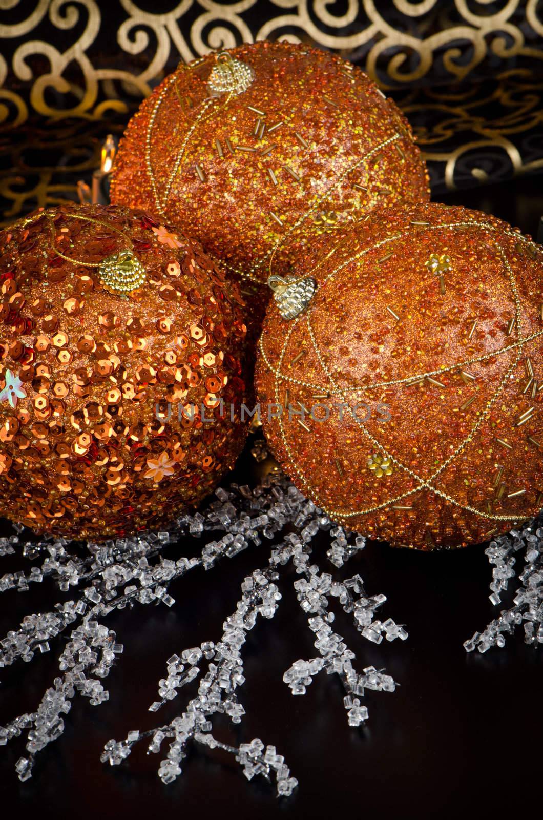 Christmas ball baubles with orange, silver and gold decoration.