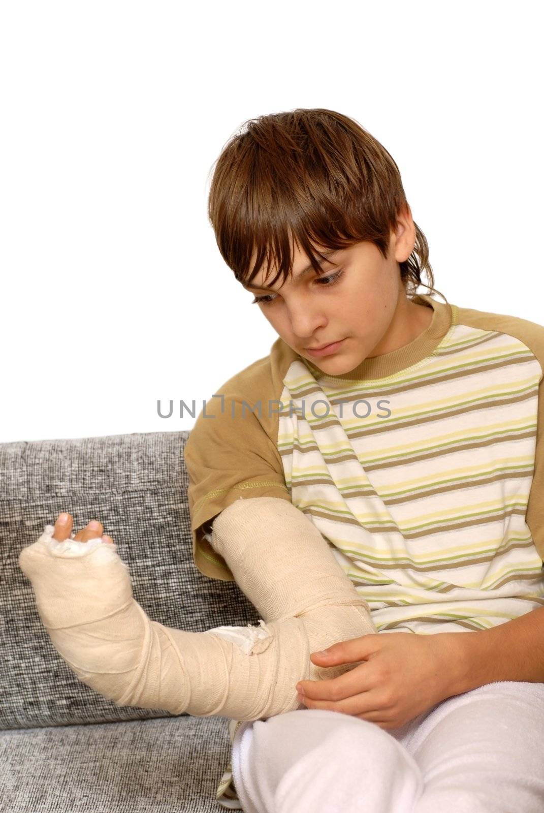 sad teenage caucasian boy with broken arm bone