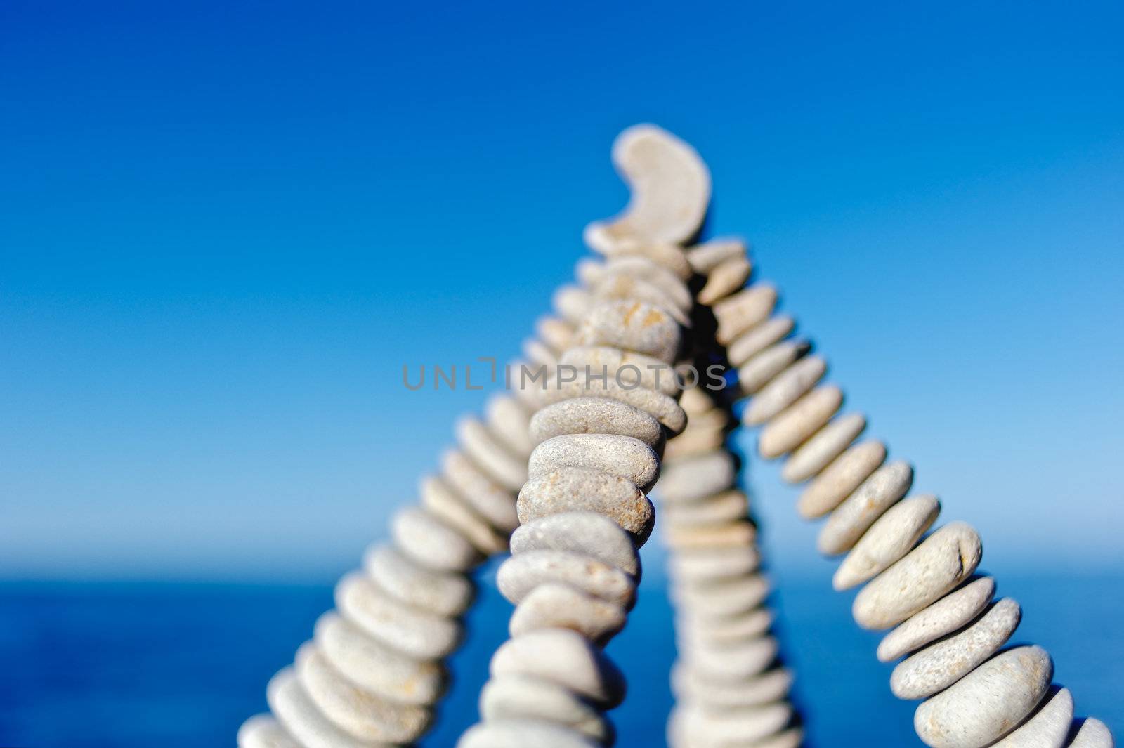Pyramidal group of small pebbles in the balance on the seacoast