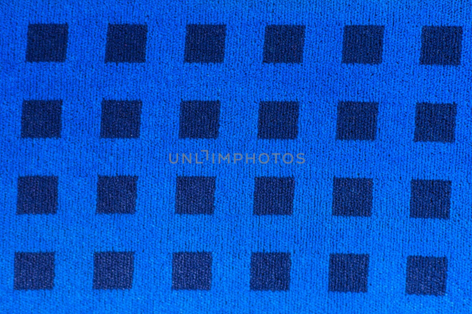 Blue woven fabric with pattern of darker squares.