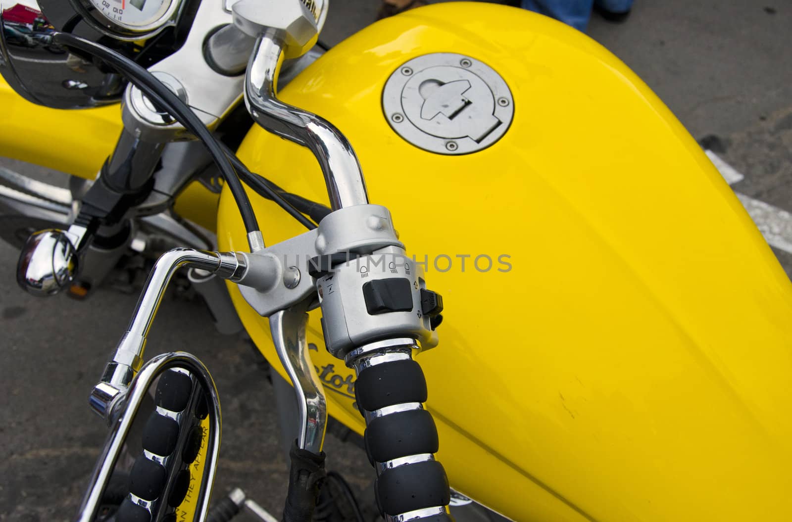 Motorcycle wheel and yellow petrol tank details. Risky for health vehicle.