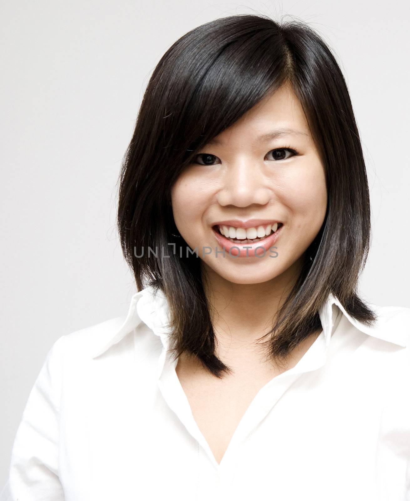 Young Asian woman on grey background