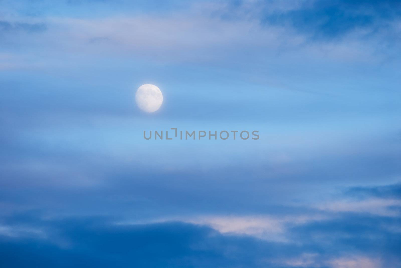 The Moon and clouds at sunset by CharlesBolin