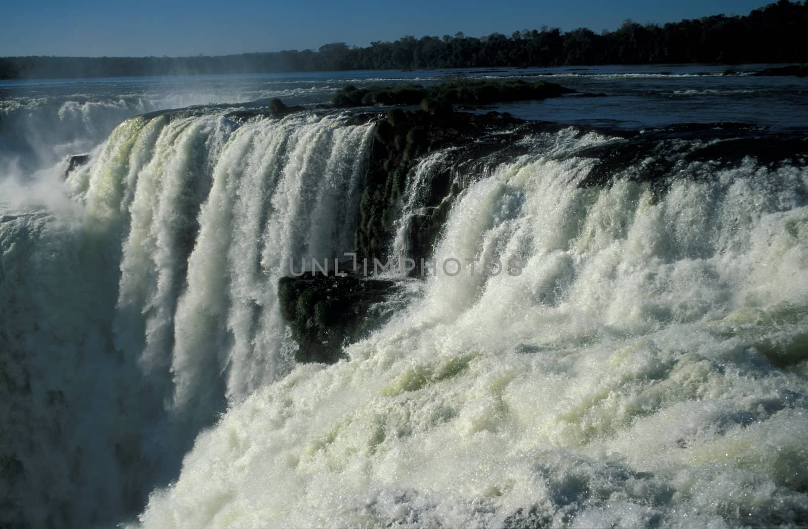 Torrent of water flowing over the lip of Iguacu Falls in Brazil.