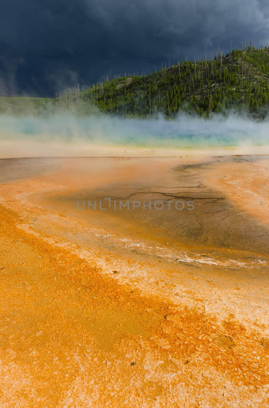 Grand Prismatic Spring and dark storm clouds, Yellowstone National Park, Wyoming, USA by CharlesBolin