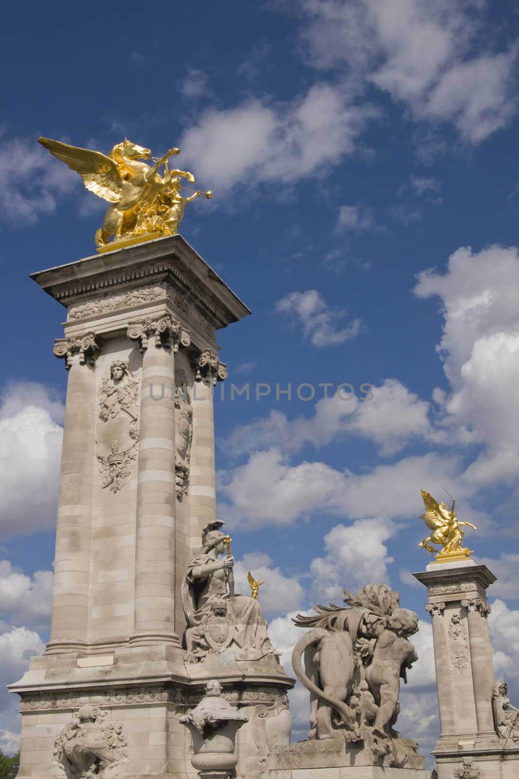 Golden statues of winged horses on top of pillars decorate the Pont Alexandre III in Paris, France.