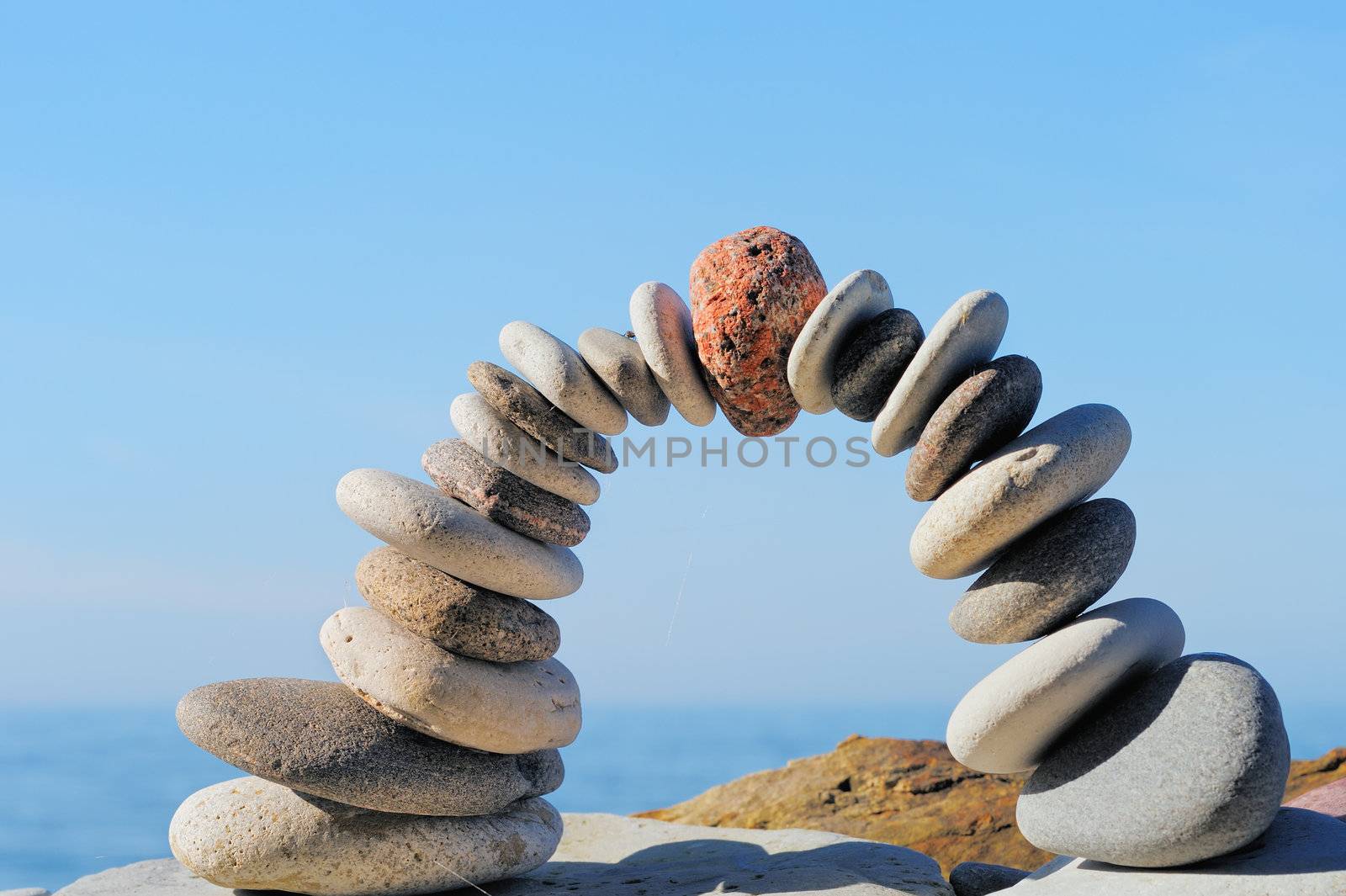 Red stone in the center arch of pebbles