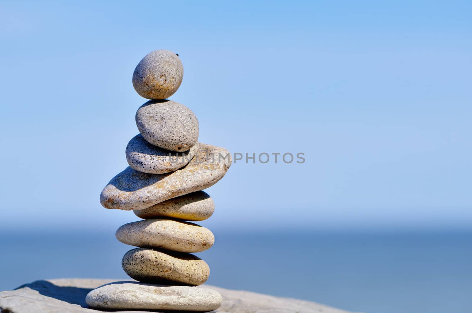 Pile of pebbles in the balance on the seacoast