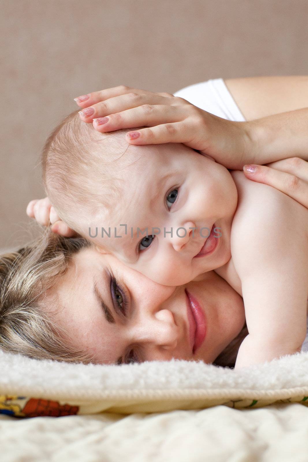 child on the hands of his mom