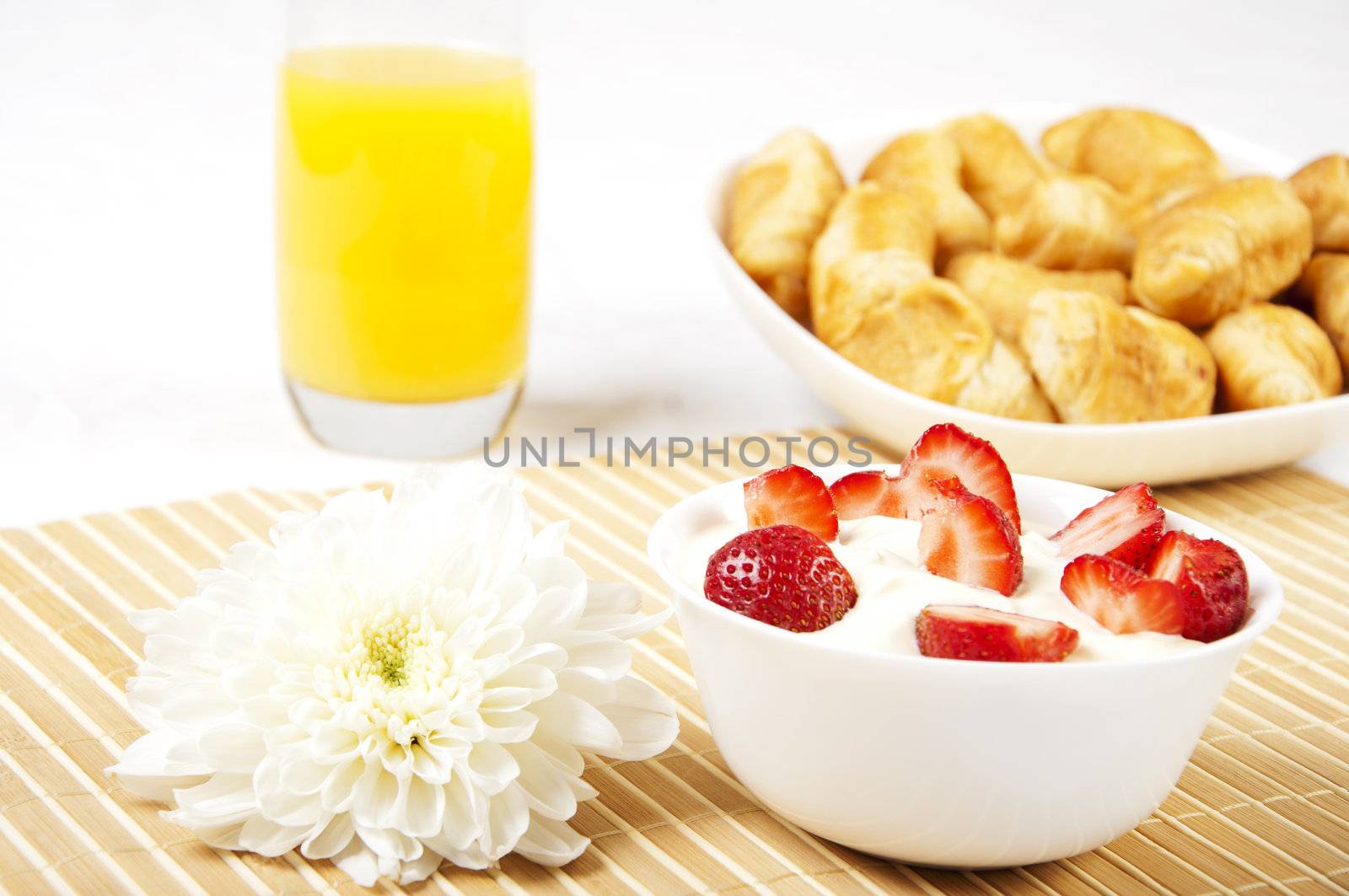 concept Breakfast: orange juice, croissants and Berries on a table