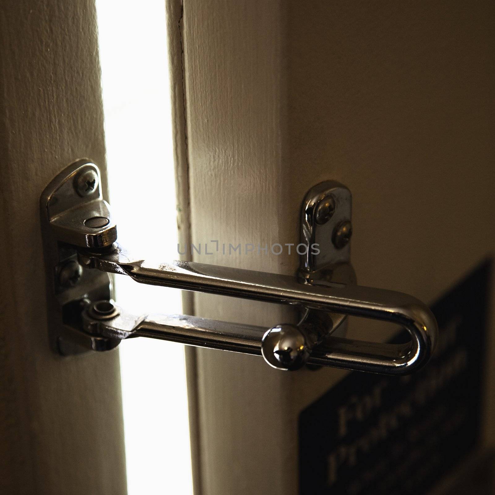 Close-up of security lock on motel or hotel room door.