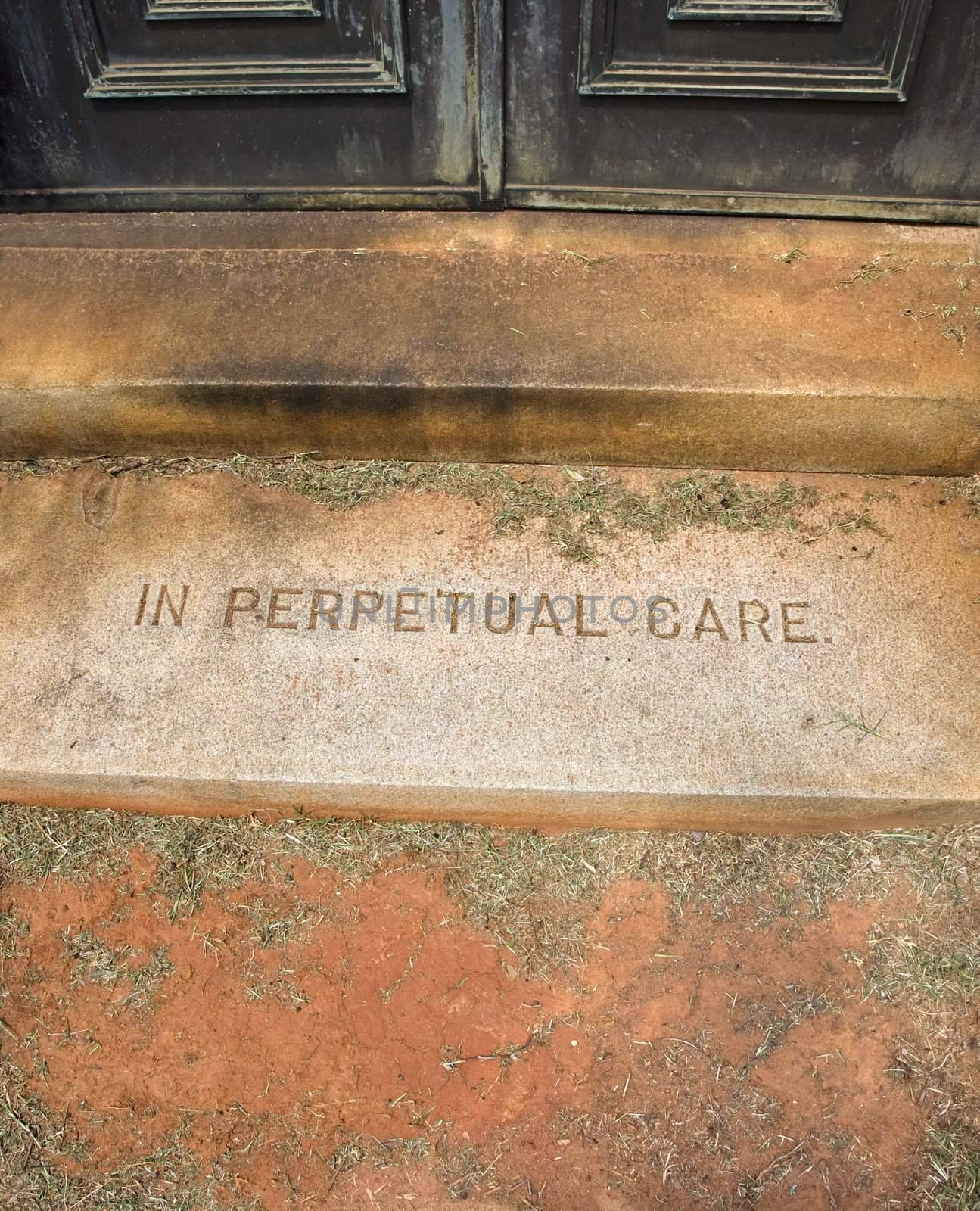 Mausoleum entrance in graveyard with words, "In Perpetual Care"