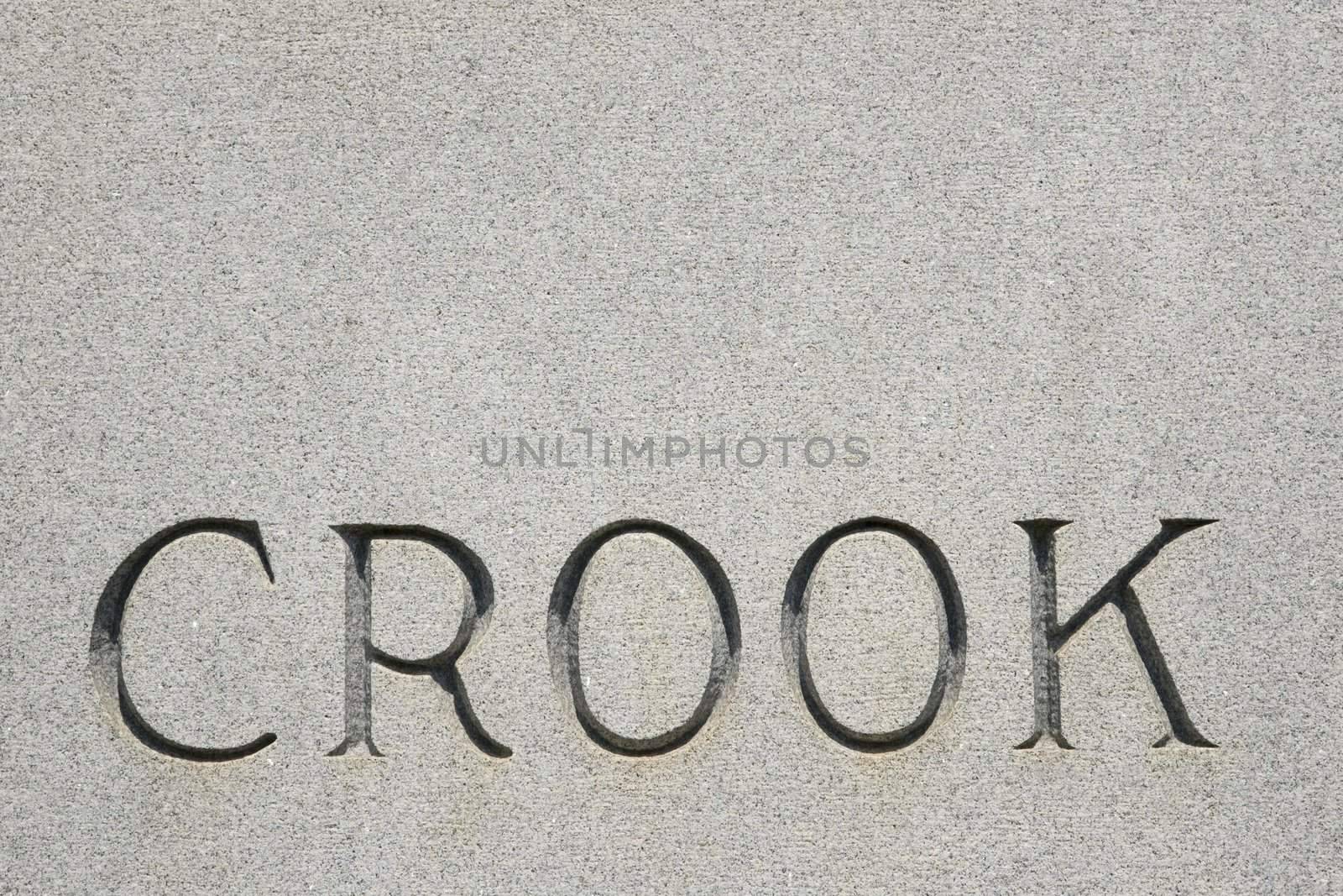 Word "crook" on gravestone. by iofoto