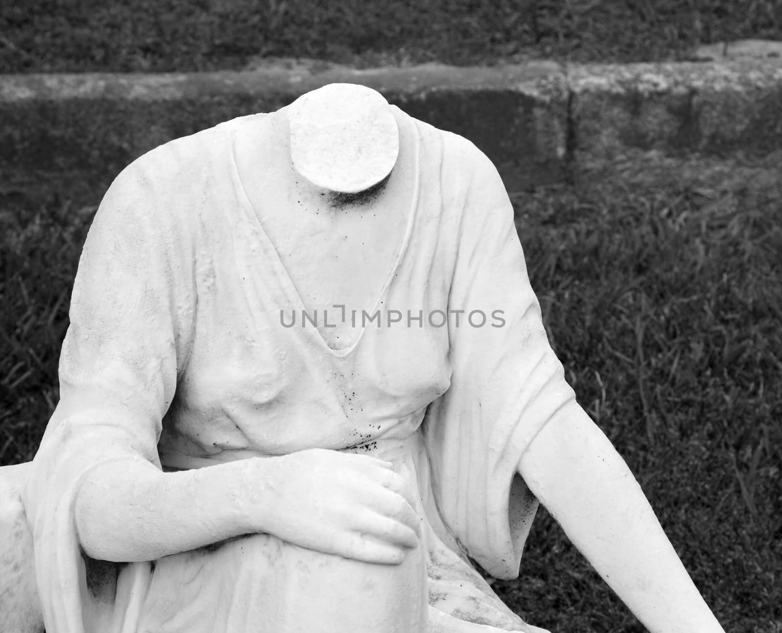 Headless statue in graveyard. by iofoto