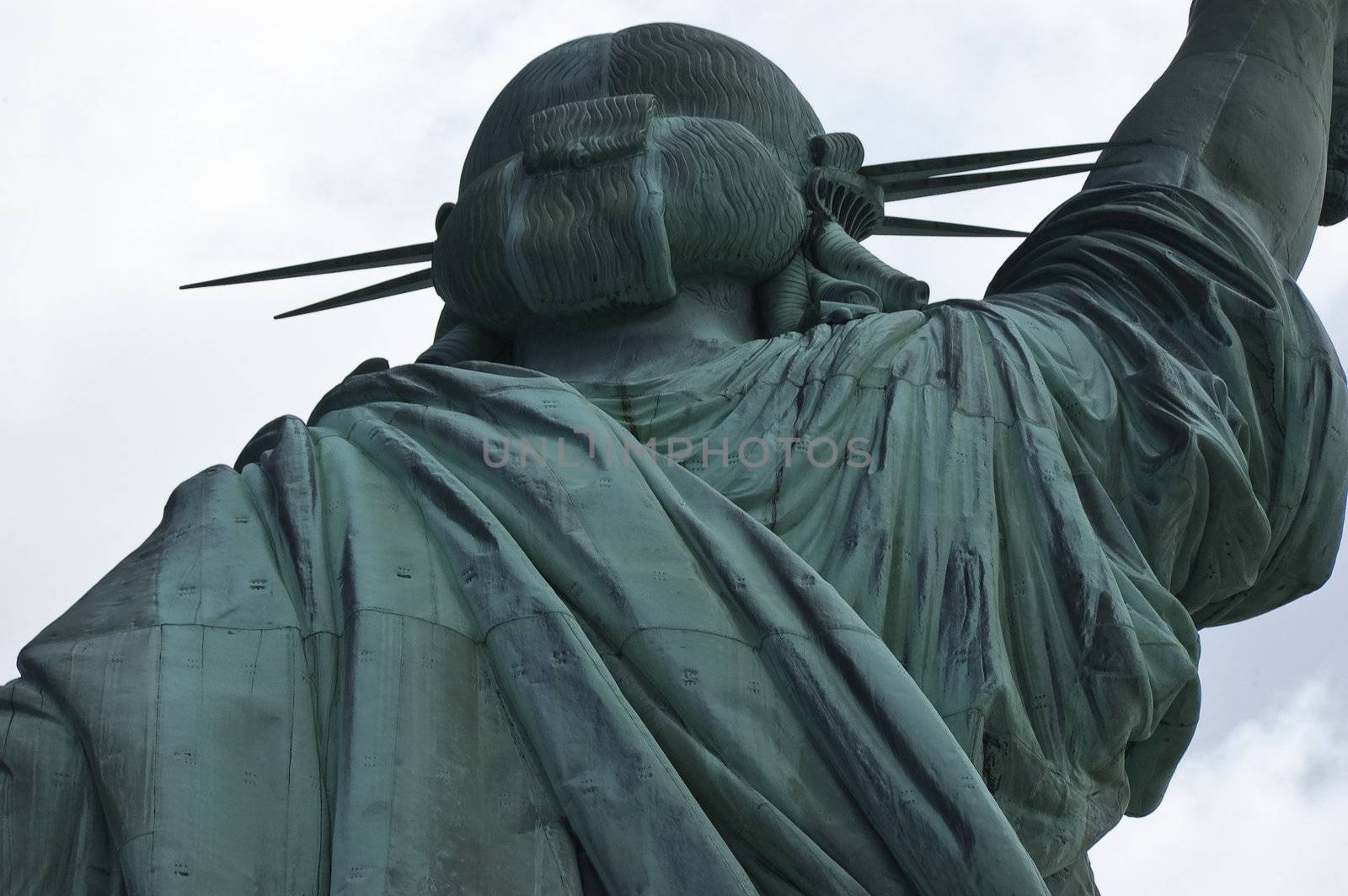 Close-up, upper section, Statue of Liberty from back showing head and part of right arm against the sky, New York City, USA