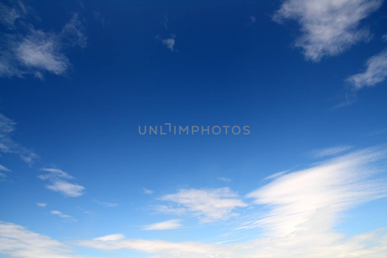 deep blue sky with clouds by Mikko