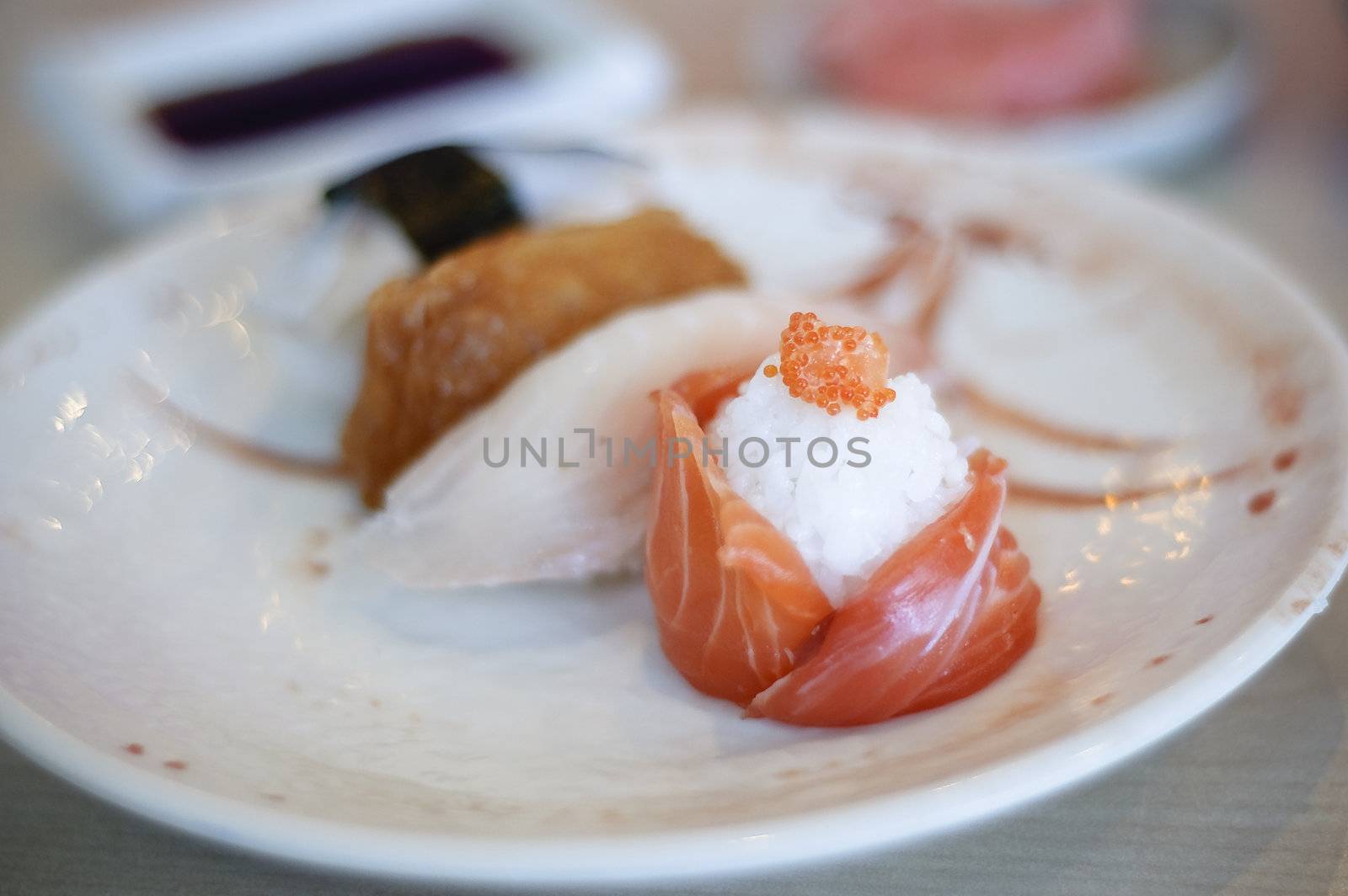 Pink salmon sushi on white plate