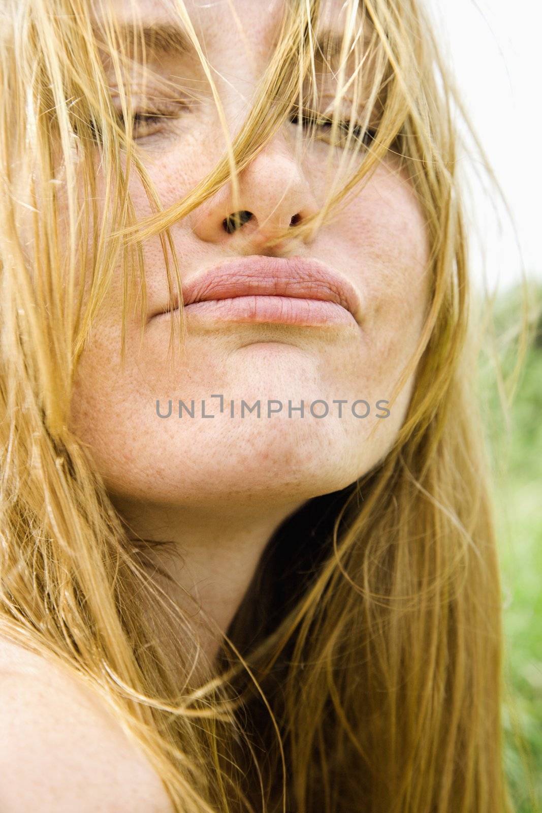Close up portrait of attractive redheaded woman making a funny face.
