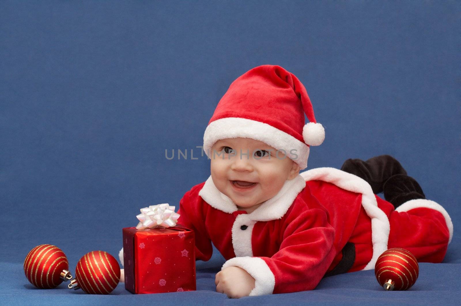 baby in santa's suit with gift and balls by zhu_zhu