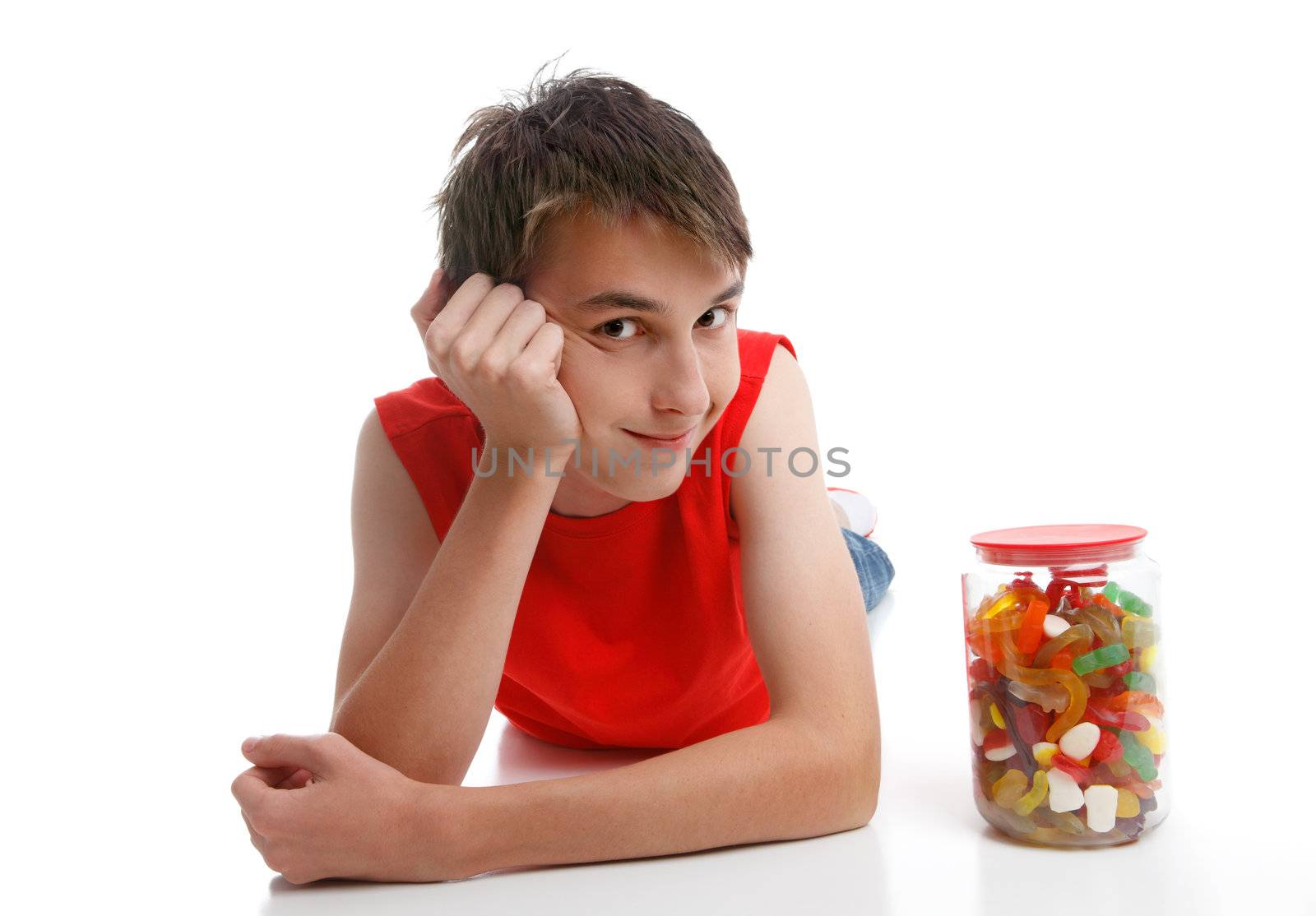 Boy beside an assortment of mixed confectionery by lovleah
