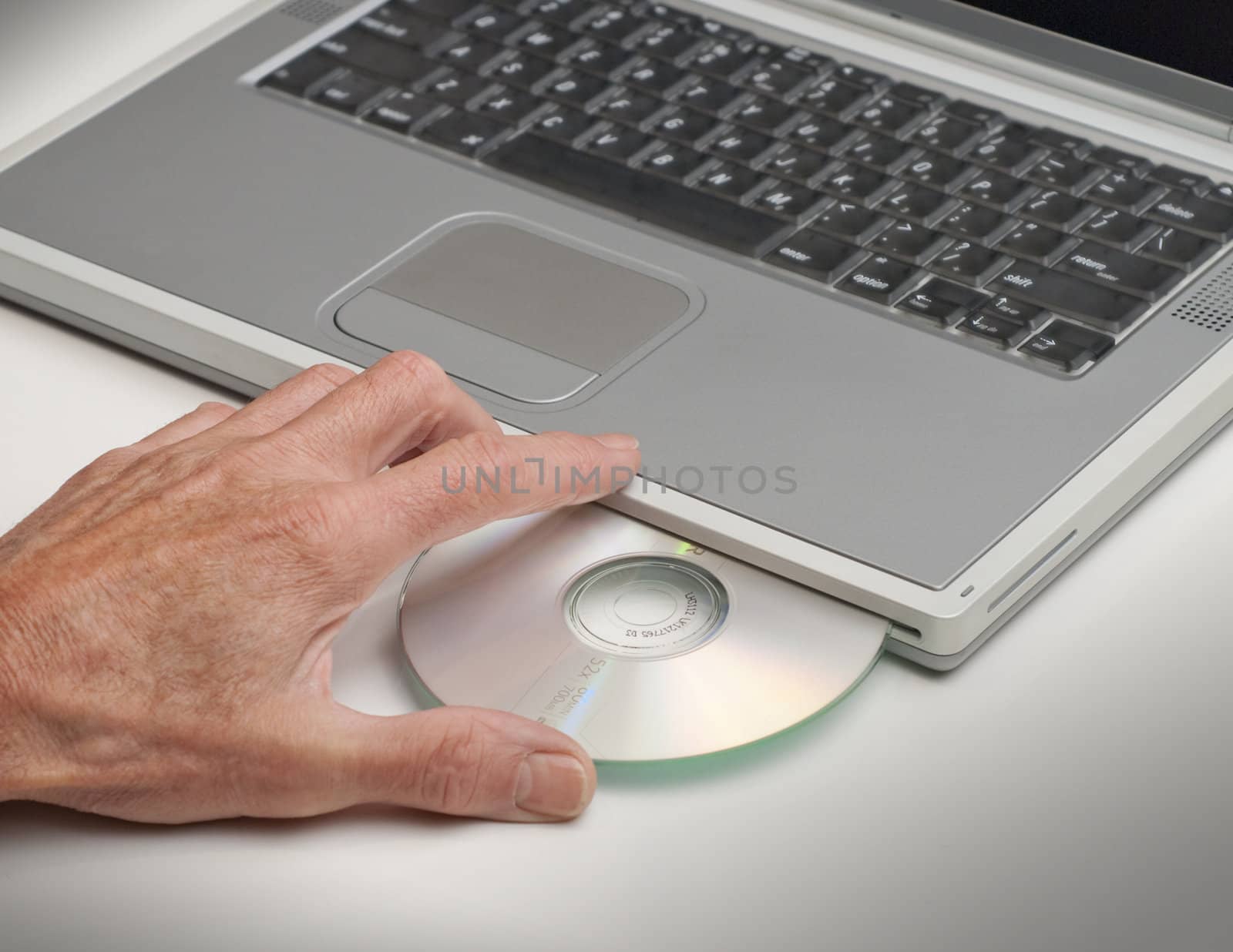 Loading laptop computer with CD or DVD
