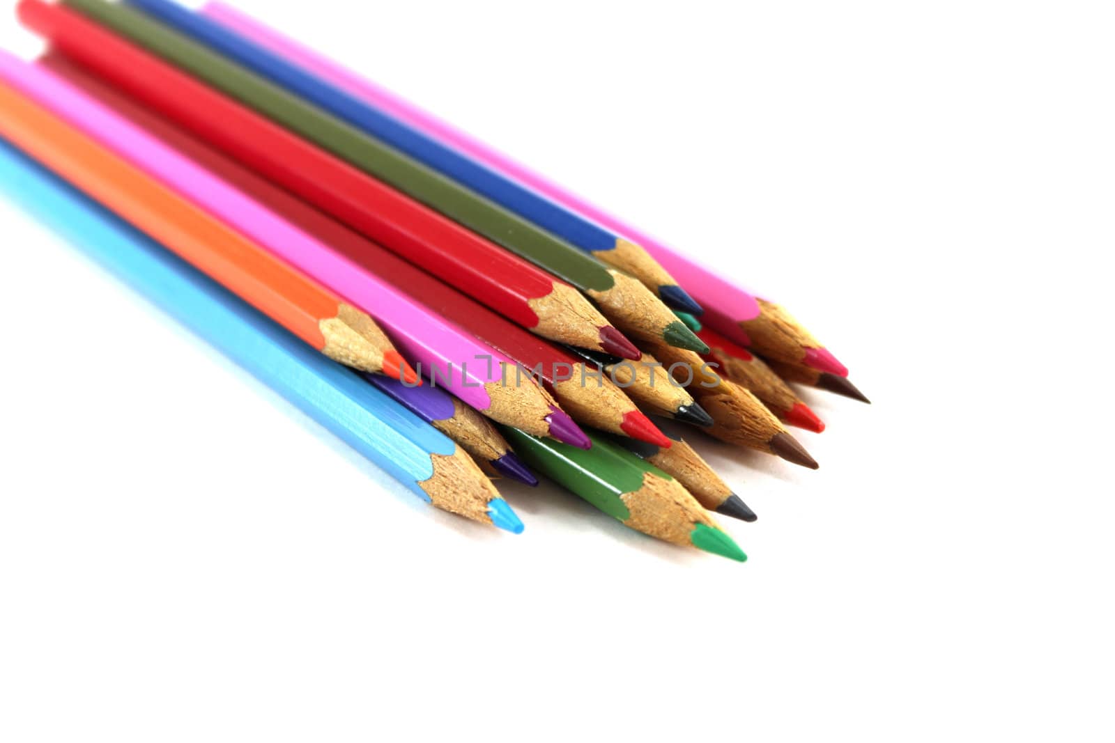 Close up of colored pencils with different color over white background.