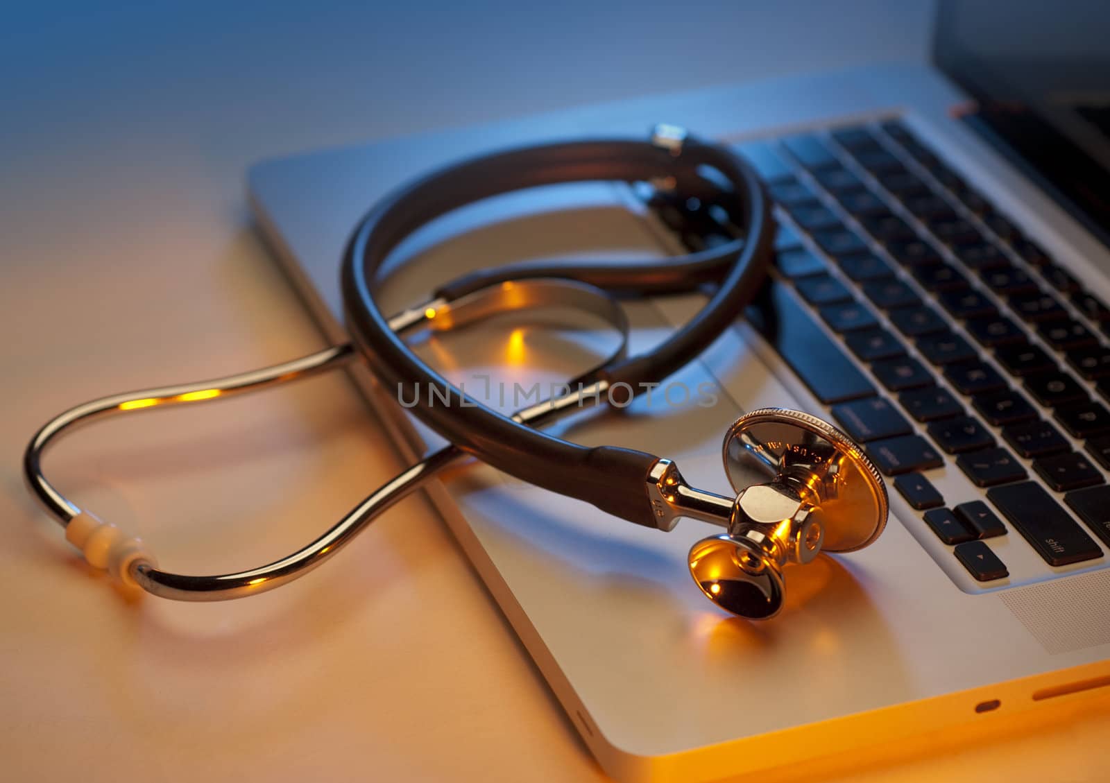 Medical stethoscope on a laptop computer, closeup