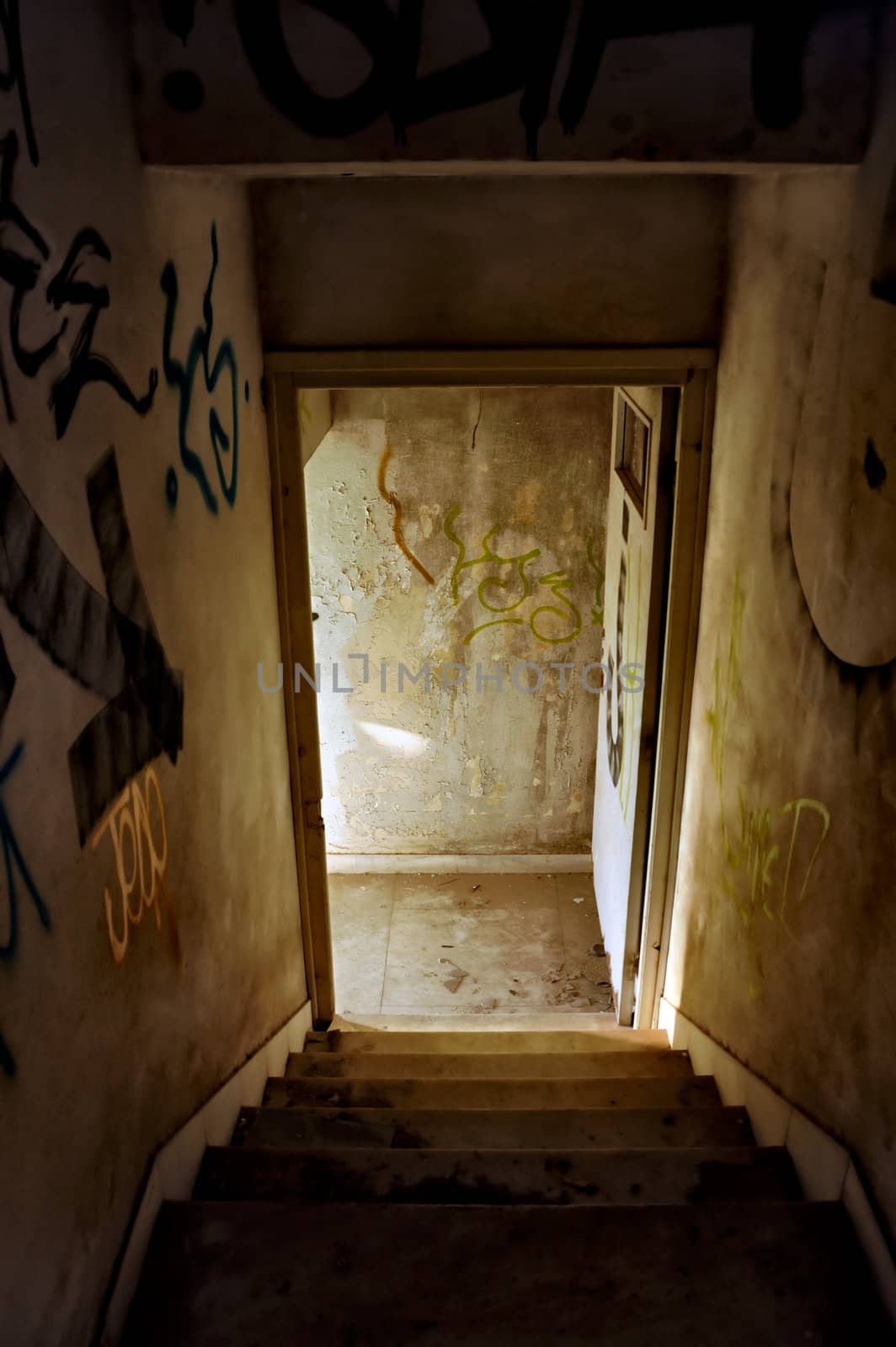 Staircase and exit door of an abandoned house.