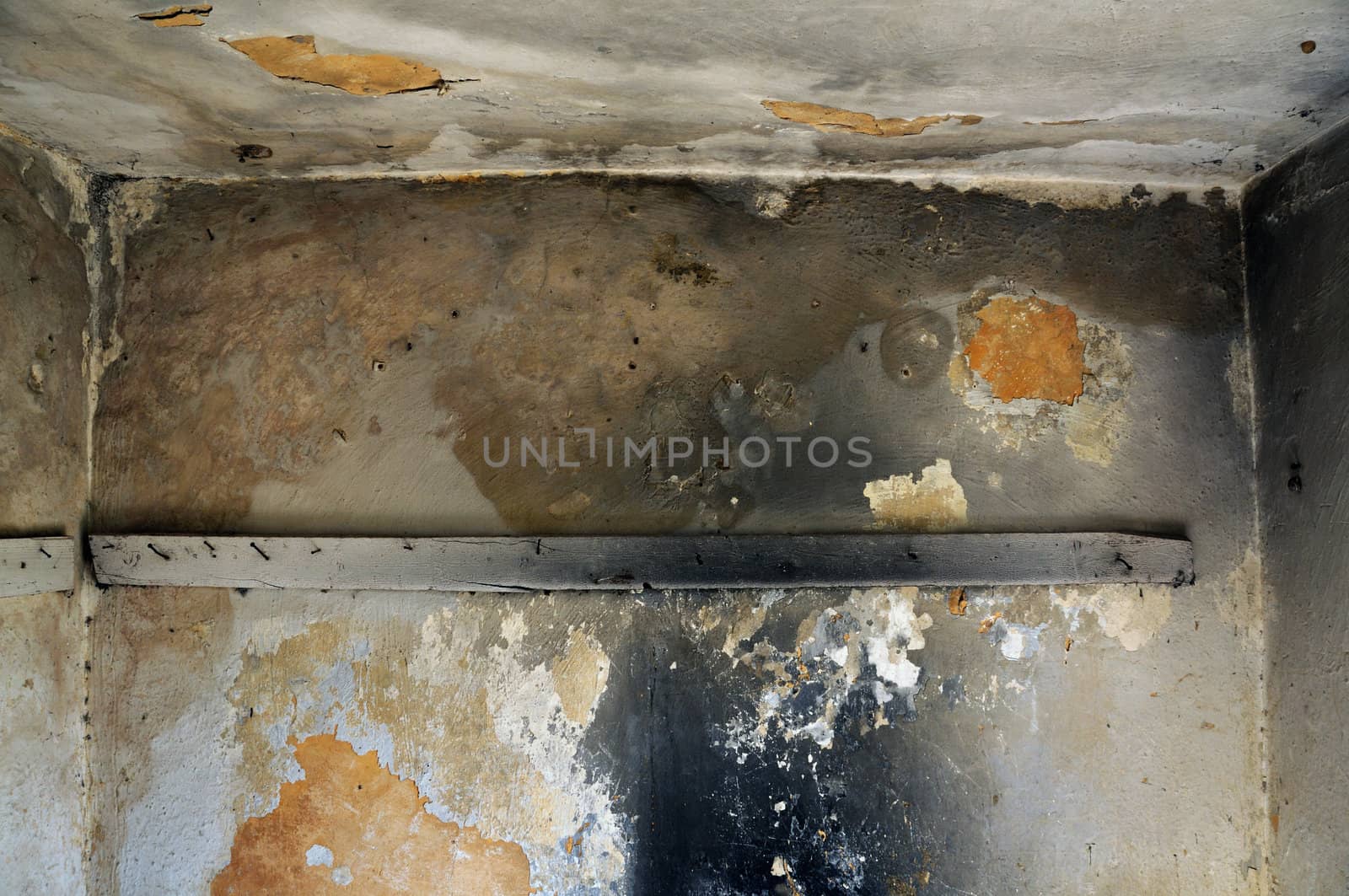 Empty room and moldy crumbling wall texture. Abandoned house interior.