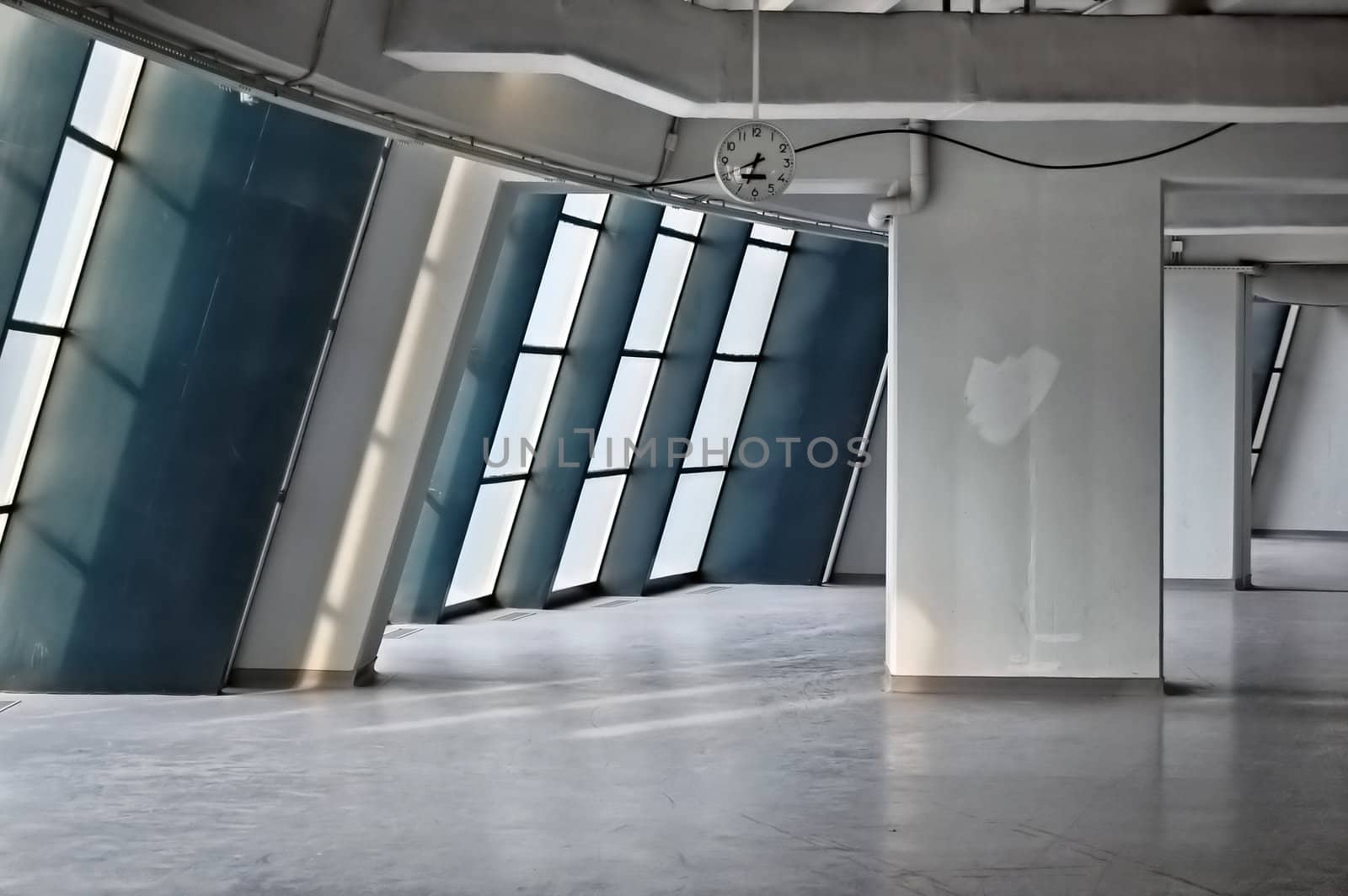 Empty industrial hallway and clock. Modern architecture.
