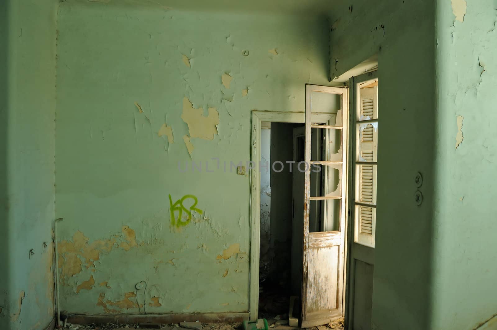 Empty room and textured peeling paint wall. Abandoned house interior.