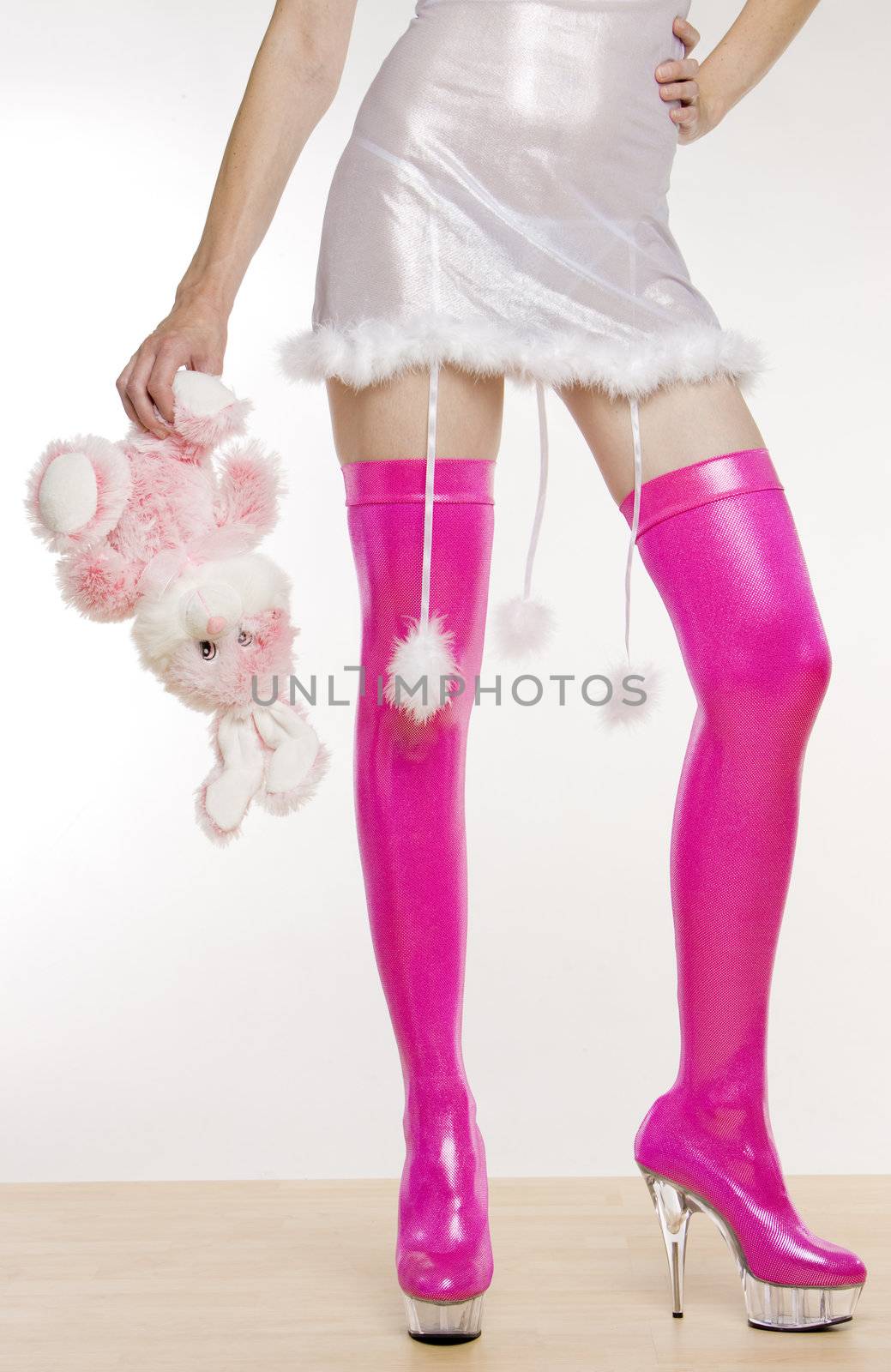 extravagant pink boots and hand holding a rabbit toy