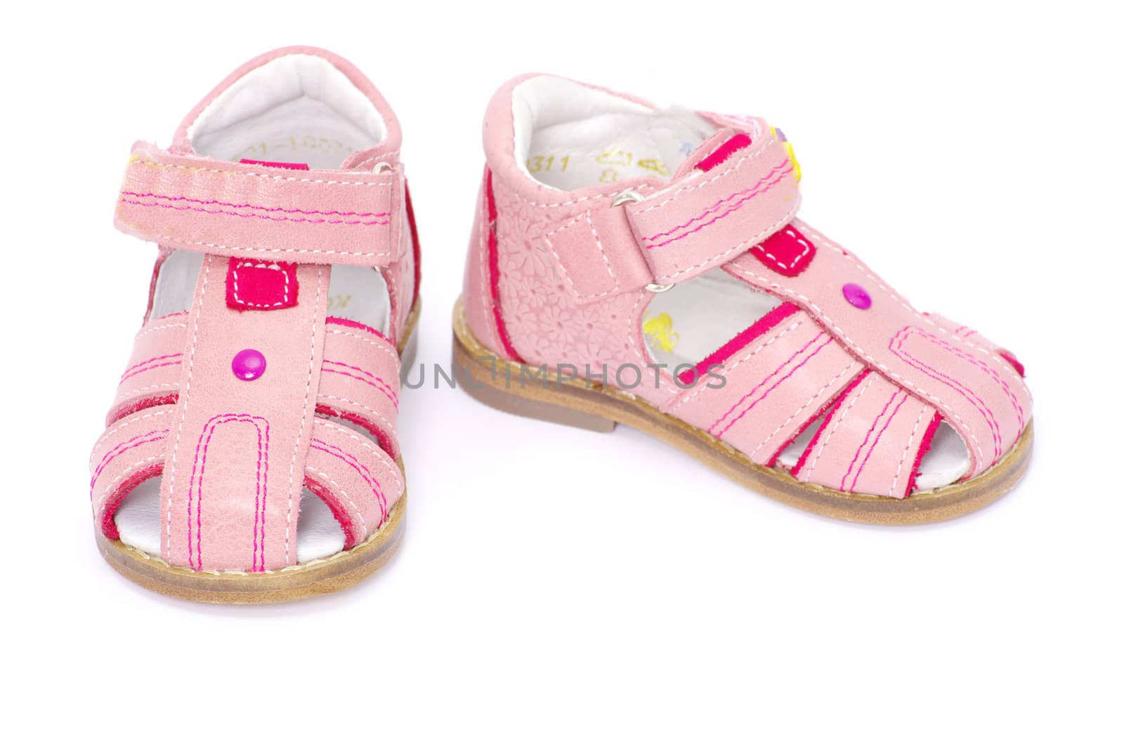 pink child's sandals isolated on white